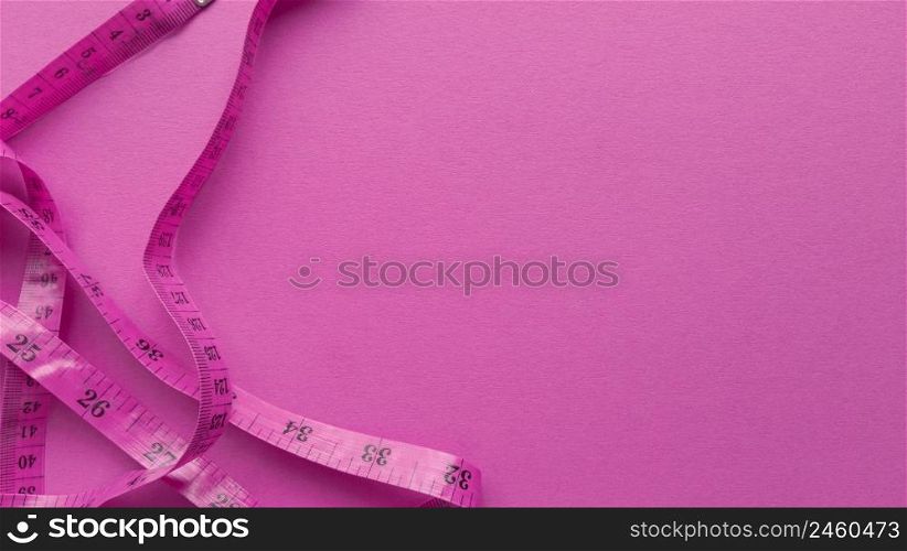 Pink centimeter on pink background. Simple flat lay with pastel texture. Fitness concept. Stock photography.. Pink centimeter on pink background. Simple flat lay with pastel texture. Fitness concept. Stock photo.