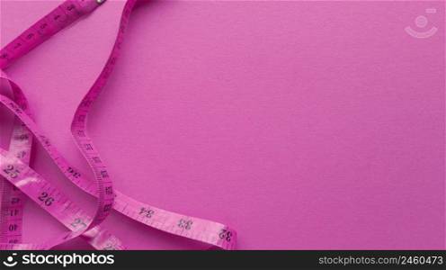 Pink centimeter on pink background. Simple flat lay with pastel texture. Fitness concept. Stock photography.. Pink centimeter on pink background. Simple flat lay with pastel texture. Fitness concept. Stock photo.