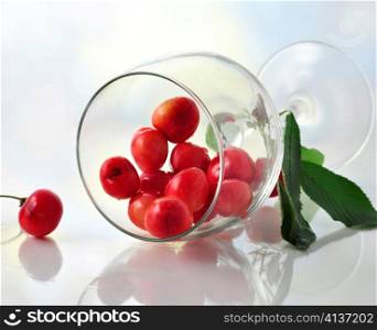 pink cherries in a glass , close up