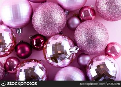 Pink Christmas decorative balls close up festive background. Pink Christmas balls