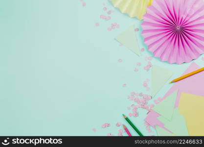 pink circular paper fan made with paper mint green backdrop