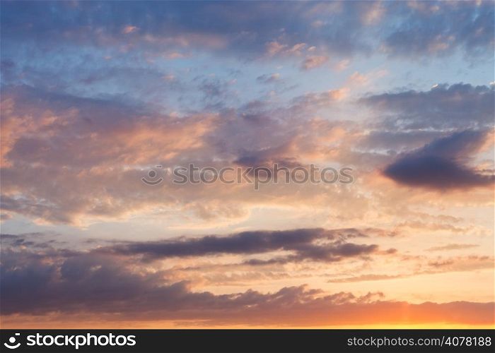 pink clouds in blue sky at summer sunset