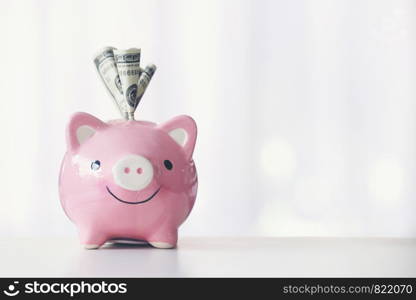 pink color piggy bank on white table, saving concept