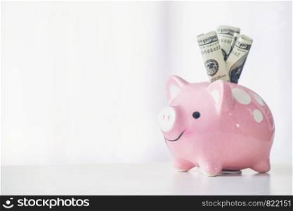 pink color piggy bank on white table, saving concept