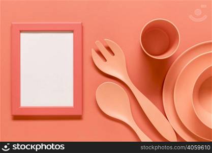 pink composition with empty frame plastic dishes