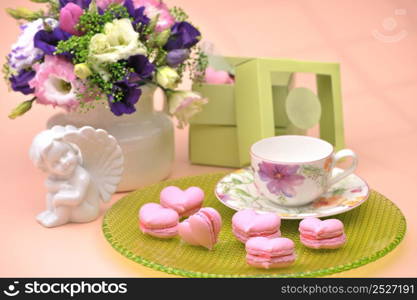 pink cookies in the shape of hearts on a plate with angels and flowers on Valentine&rsquo;s Day. cookies in the shape of hearts on Valentine&rsquo;s Day