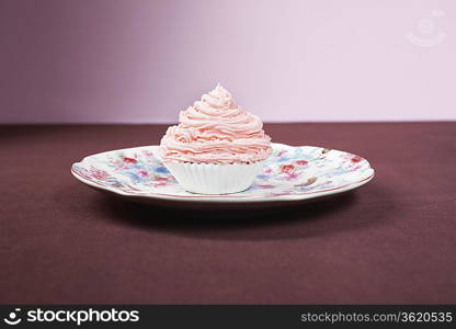 Pink cupcake on plate