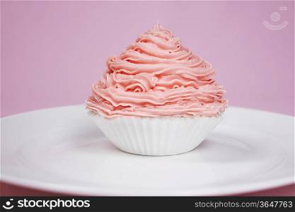 Pink cupcake on plate