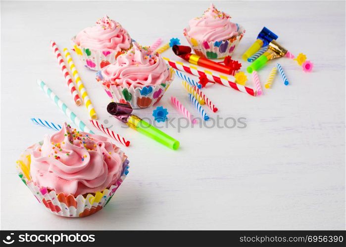 Pink cupcakes and candles birthday background. Pink cupcakes and candles birthday background . Birthday cupcakes. Gourmet cupcakes. Sweet dessert. Sweet pastry. Birthday invitation. Birthday mockup. Styled desktop. Birthday background.