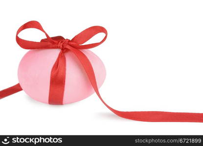 Pink Easter egg with a red ribbon isolated on white background