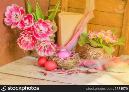 Pink Easter eggs in fresh flowers tulip. Easter background with copy space. Easter background with pink tulips and easter egg