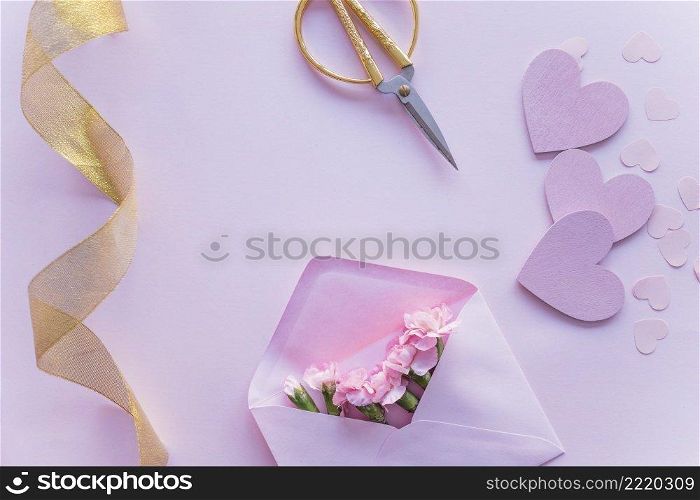pink flowers envelope with paper hearts table