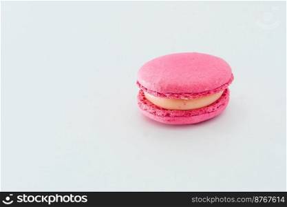 Pink French macaroon isolated on white background. Tasty colourful macaroons. Cookie made of two smooth halves, fastened with stringy fillings. French pastry made from egg whites.. Pink French macaroon isolated on white background. Tasty colourful macarons. Cookie made of two smooth halves, fastened with stringy fillings. French pastry made from egg whites.