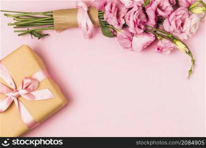 pink fresh eustoma flower bouquet gift box against pink background