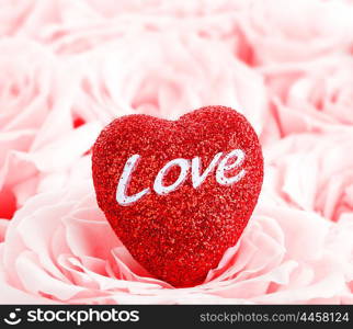 Pink fresh roses background with red heart, love concept image