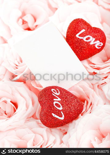 Pink fresh roses background with red hearts &amp; blank greeting card, love concept