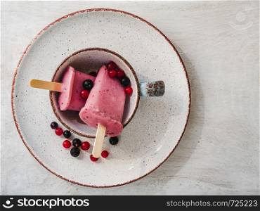 Pink fruit ice cream on a vintage plate. Close-up, top view. Concept of tasty and healthy food. Pink fruit ice cream on a vintage plate