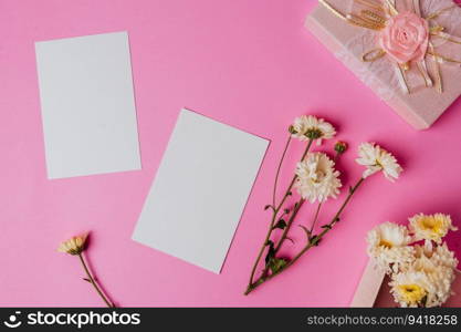 pink gift box, flower and blank card on pink background