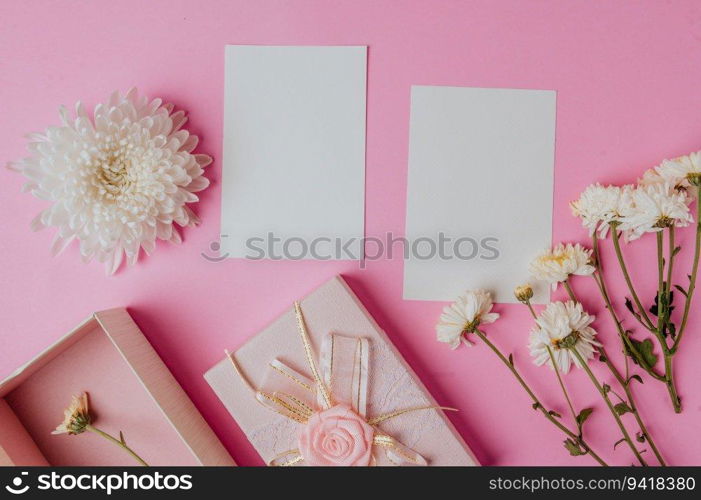 pink gift box, flower and blank card on pink background