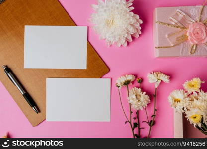 pink gift box, flower, pen, wood board and blank card on pink background