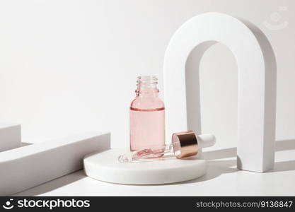 Pink glass bottle of cosmetic liquid transparent gel on white background. Dropper bottle, hyaluronic acid, oil, serum, skin care product. Pink glass bottle of cosmetic liquid transparent gel on white background. Dropper bottle, hyaluronic acid, oil, serum, skin care product.