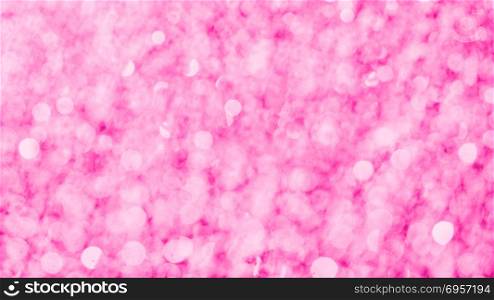 Pink glittering background. Pink bokeh abstract texture.. Pink glittering background