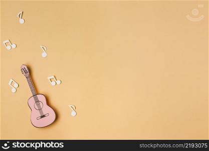 pink guitar with white musical notes