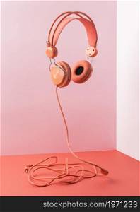 pink headphones with cable flying. High resolution photo. pink headphones with cable flying. High quality photo