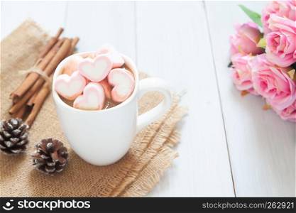 Pink heart marshmallows on hot chocolate in white cup. Love concept