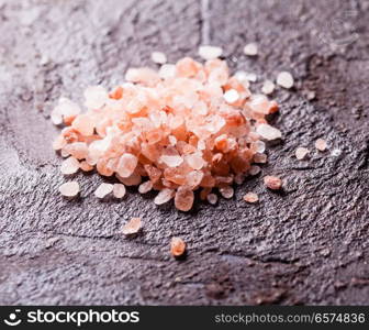 Pink Himalayan sea salt on slate background. Various tupes of salts