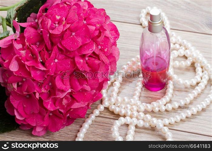 pink hortensia  flowers and bottle of fragrance