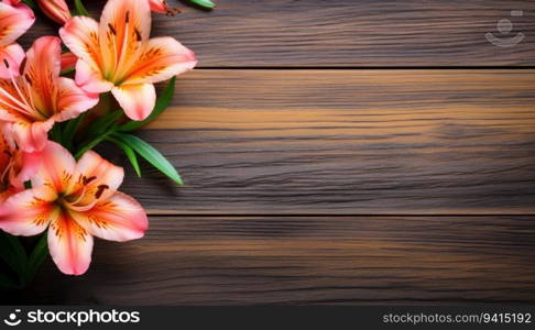 Pink lily flowers on wooden background. Top view with copy space