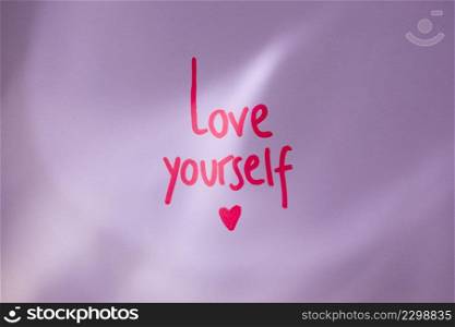 pink love yourself inscription table