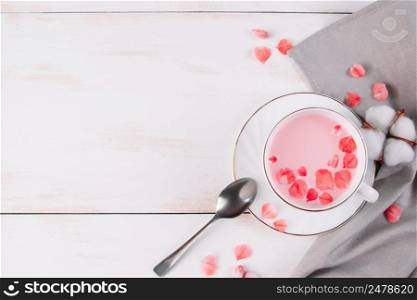 Pink matcha with rose petals. Relaxing drink for sleepy time. Trendy vegan tea on a white background. Place for text. Pink matcha with rose petals. Relaxing drink for sleepy time. Trendy vegan tea on white background.