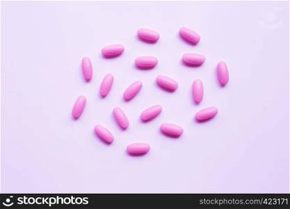 Pink medicine pills on pink tone background