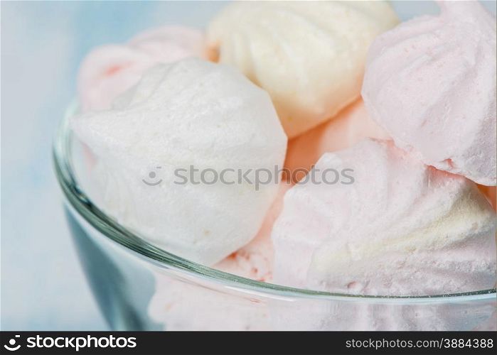 Pink meringue in a glass bowl close-up