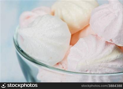 Pink meringue in a glass bowl close-up
