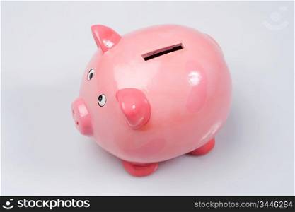 Pink money box a over white background