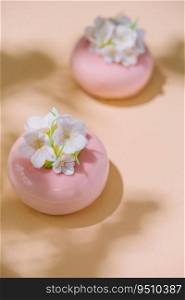 Pink mousse cakes decorated with white flowers