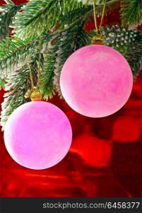 Pink New Year&rsquo;s balls on a branch of a Christmas tree