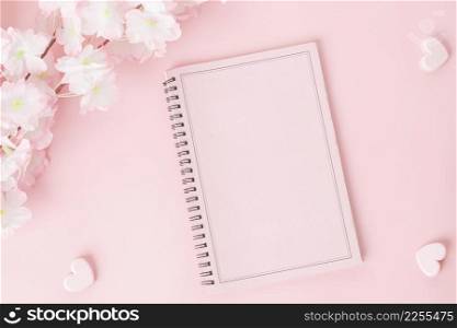 Pink notebook with flower on a pink background