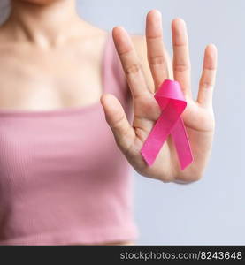 Pink October Breast Cancer Awareness month, woman hand hold pink Ribbon and wear shirt for support people life and illness. National cancer survivors month, Mother and World cancer day concept