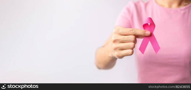 Pink October Breast Cancer Awareness month, woman hand hold pink Ribbon and wear shirt for support people life and illness. National cancer survivors month, Mother and World cancer day concept