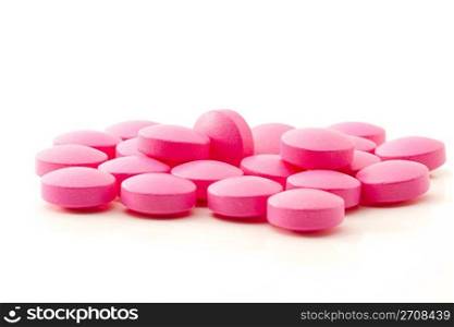 Pink painkillers. some pink painkiller pills on white background