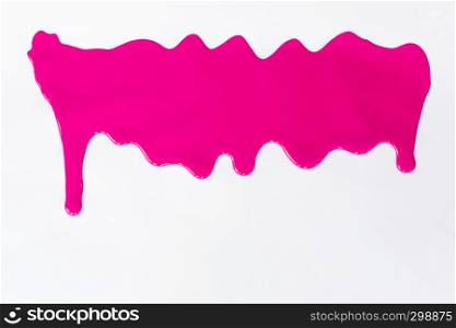 Pink paint dripping on a white background