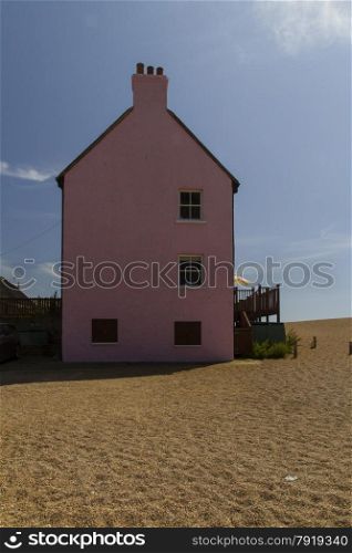 Pink painted house, West Bay Beach, Bridport, Dorset, England, United Kingdom