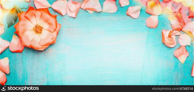 Pink pale rose petals border with bokeh on blue turquoise background, top view . Love , romantic and Valentines day concept
