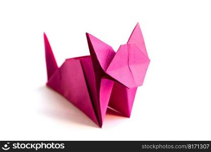 Pink paper cat origami isolated on a blank white background.. Pink paper cat origami isolated on a white background