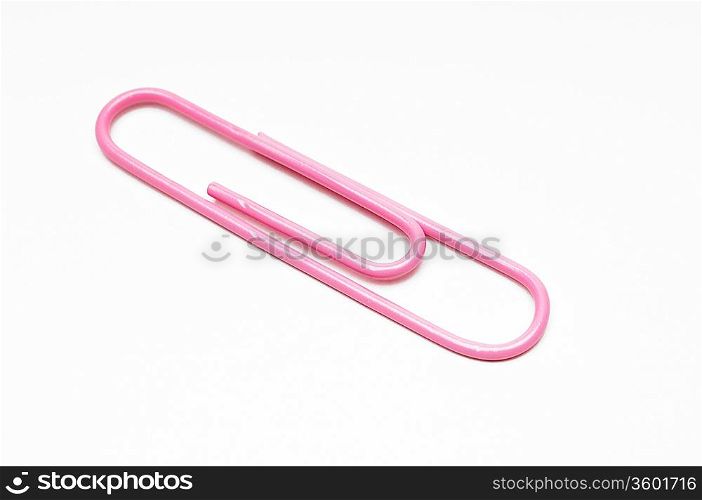 Pink paper clip on white background