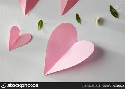 pink paper hearts handmade on a white background.. Overhead flat lay valentine day background.